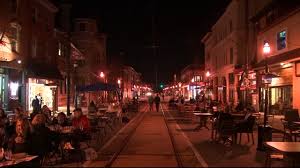 State Street at night — outdoor dining and trolley tracks in Media, PA